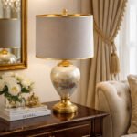 Luxury ceramic table lamp with gold accents and fabric shade in classic living room interior