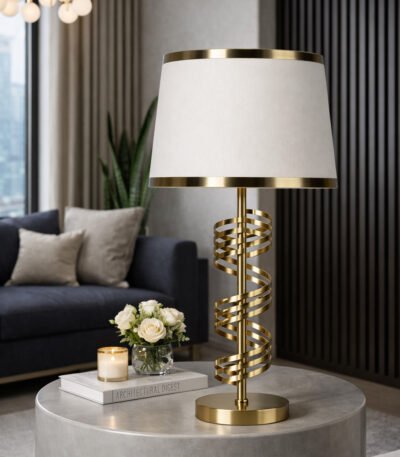 Modern gold spiral table lamp with white fabric shade placed on a round stone coffee table in a luxury living room.